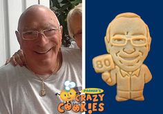 an older man and young woman smiling next to a cookie with the image of a cartoon character on it