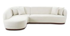 a large white couch with pillows on it's back and side ends, sitting in front of a white background