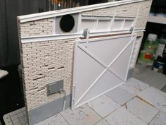 a model of a brick building with a white door