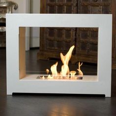 a white fire place sitting on top of a wooden floor