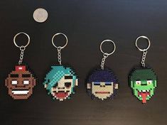 four pixel key chains with different characters on them