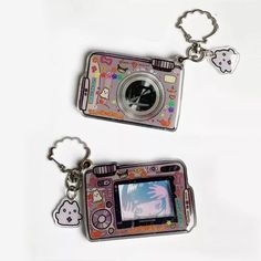 two key chains that have pictures on them