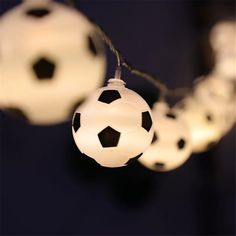 some white and black balls are hanging from a string