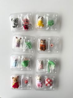 small animal magnets in plastic bags sitting on a white counter top, each with different designs and colors