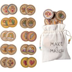 wooden badges with words make match in front of a drawstring bag filled with magnets