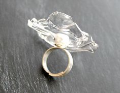 A large cocktail ring made of plastic, incredibly similar to glass, but it can not be broken. The size of the transparent disk about 5 cm, pearl size 1 cmThe base of the ring is made of 925 silver, detachable, which allows you to wear the ring on any finger. Light, stylish and beautiful ring! At your request, I can make a necklace, bracelet, earrings , brooch. All you have to do is write me a letter.