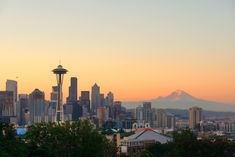 the seattle skyline at sunset with mt rainier in the background