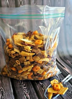 a bag filled with cheetos sitting on top of a wooden table