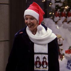 a woman wearing a santa hat and scarf