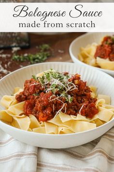 two white bowls filled with pasta and sauce