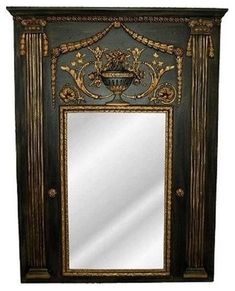 an ornate mirror is hanging on the wall