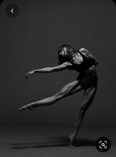 a ballerina in black and white poses for the camera with her legs spread out