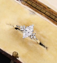 a diamond ring sitting on top of a wooden box