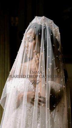 a woman wearing a wedding veil and holding a baby in her arms with the words pearled dropgahed on it