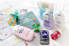 various baby products are laid out on a bed