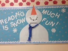 a bulletin board with a snowman wearing a red hat and blue scarf on it