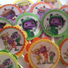 there are many cupcake toppers with cartoon characters on them, all in different colors