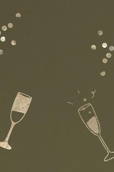 two champagne flutes with confetti falling out of the top and on the bottom