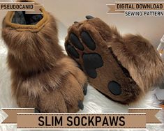 a pair of slippers with paw prints on them and the words slim socks written below