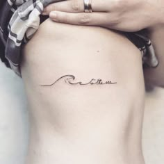 a woman's stomach with the word breathe tattooed on it