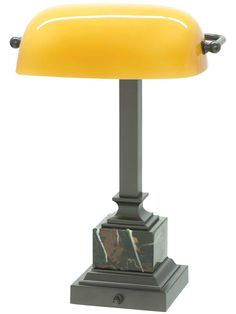 a table lamp with a yellow shade on it