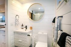 a white bathroom with black and white accessories