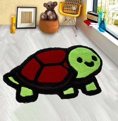 a rug with a turtle on the floor next to a teddy bear