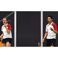 two tennis players are laughing and holding racquets