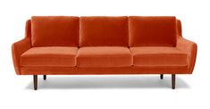 an orange couch sitting on top of a white floor