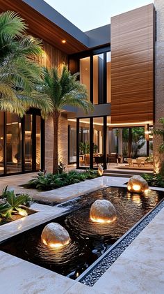 a modern house with water feature and palm trees