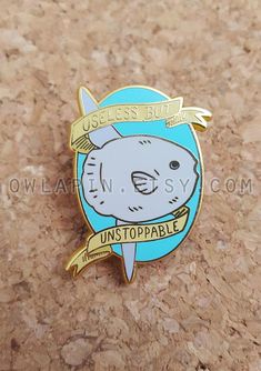 a blue and gold colored pin with a koala on it's back that says, use less fuel unstopable