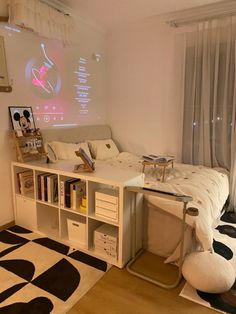 a living room with a white couch and black and white rugs on the floor