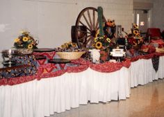 a long table with sunflowers and other items on it