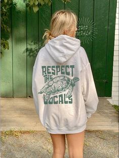 Respect The local Hoodie Turtle lover gift Hoodie Trendy Hoodies Indie Hoodie Y2k Sweatshirt This unisex heavy blend hooded sweatshirt is relaxation itself. Made with a thick blend of cotton and polyester, it feels plush, soft and warm, a perfect choice for any cold day. In the front, the spacious kangaroo pocket adds daily practicality while the hood's drawstring is the same color as the base sweater for extra style points. .: Made with a medium-heavy fabric (8.0 oz/yd² (271 g/m that consists of 50% cotton and 50% polyester for that cozy feel and warmth you need in a hoodie. .: The classic fit along with the pouch pocket and the tear-away label make for a highly comfortable, scratch-free wearing experience.  .: The color-matched drawcord and the double-lined hood add a stylish flair and d Respect The Locals Hoodie, Pre-shrunk White Casual Hoodie, Green Casual Pre-shrunk Hoodie, Casual Green Pre-shrunk Hoodie, Surfer Clothing, Indie Hoodie, Turtle Hoodie, Surfer Clothes, Respect The Locals