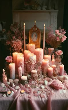 a table topped with lots of candles and flowers