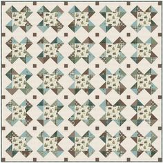 a quilt made with blue and brown squares on white fabric, the pattern is very similar to