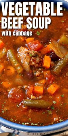 a bowl of vegetable beef soup with cabbage and carrots on the side is shown