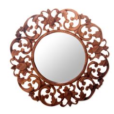 an ornate wooden mirror hanging on the wall