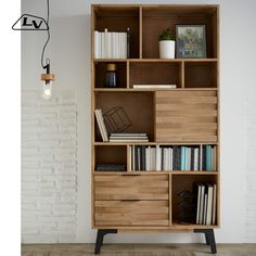 a bookshelf with many different types of books on it and a lamp hanging from the ceiling