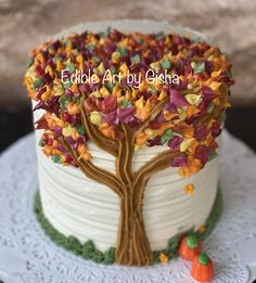 there is a cake decorated like a tree with leaves on it and the words edible art by gedraa