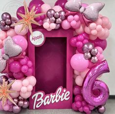 a pink frame with balloons and stars on it