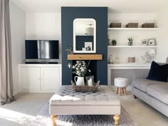 a living room filled with furniture and a fire place next to a wall mounted tv