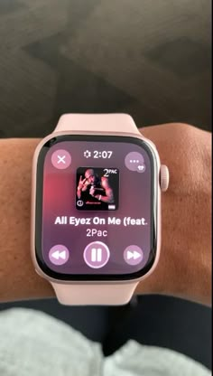 an apple watch displaying the music player on its screen