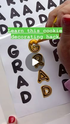 someone is writing letters on paper with colored crayons and glues to make them look like they are made out of cookies