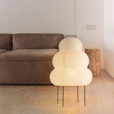 a lamp sitting on top of a table next to a couch