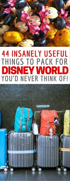 four suitcases lined up next to each other with the words disney world on them