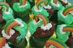 cupcakes with green frosting and rainbow decorations