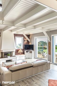 a living room filled with furniture and a flat screen tv on top of a wooden floor