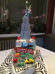 a birthday cake with the statue of liberty in the middle and legos on top