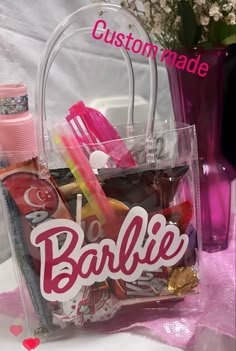 a bag filled with lots of different items on top of a pink cloth covered table